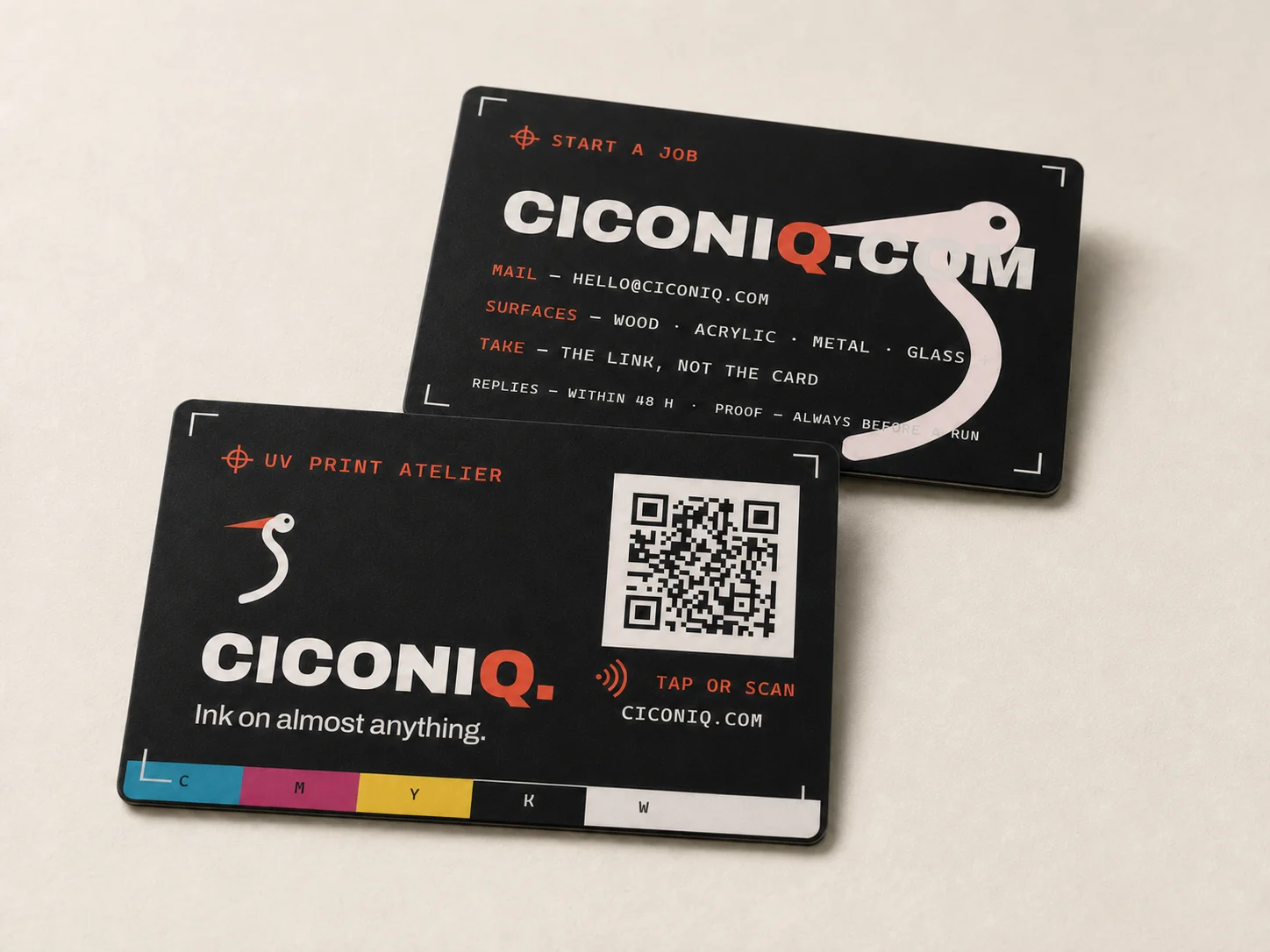 Concept of two matte black Ciconiq NFC cards with white UV artwork and red details